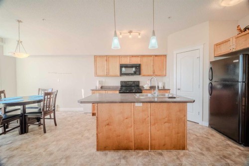 1202-2370 Bayside Road Sw, Airdrie, AB - Indoor Photo Showing Kitchen With Double Sink