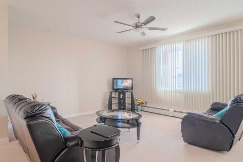 1202-2370 Bayside Road Sw, Airdrie, AB - Indoor Photo Showing Living Room