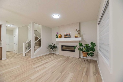65 Amblefield View Nw, Calgary, AB - Indoor Photo Showing Other Room With Fireplace