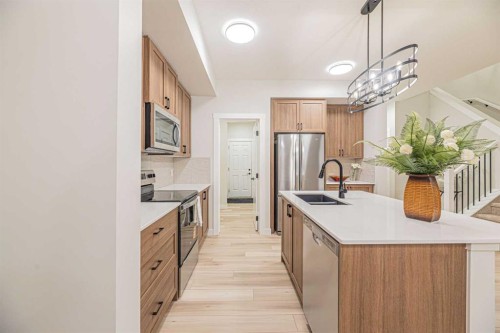 65 Amblefield View Nw, Calgary, AB - Indoor Photo Showing Kitchen With Double Sink With Upgraded Kitchen