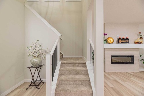 65 Amblefield View Nw, Calgary, AB - Indoor Photo Showing Other Room With Fireplace