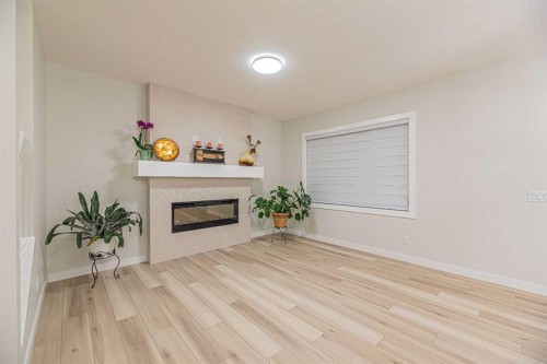 65 Amblefield View Nw, Calgary, AB - Indoor Photo Showing Living Room With Fireplace