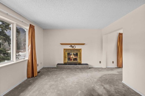 113 Larch Place, Canmore, AB - Indoor Photo Showing Living Room With Fireplace