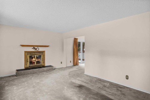 113 Larch Place, Canmore, AB - Indoor Photo Showing Living Room With Fireplace