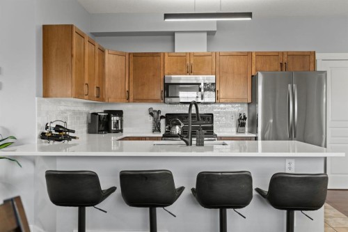 301-281 Cougar Ridge Drive Sw, Calgary, AB - Indoor Photo Showing Kitchen With Stainless Steel Kitchen With Upgraded Kitchen