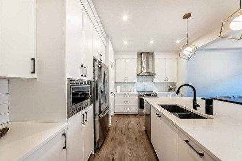 16 Lucas Passage Nw, Calgary, AB - Indoor Photo Showing Kitchen With Double Sink With Upgraded Kitchen