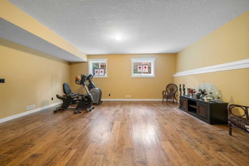 118 Riverwood Crescent Sw, Diamond Valley, AB - Indoor Photo Showing Gym Room