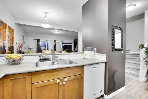 1004-720 Willowbrook Road Nw, Airdrie, AB - Indoor Photo Showing Kitchen With Double Sink