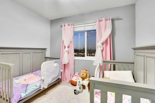 1004-720 Willowbrook Road Nw, Airdrie, AB - Indoor Photo Showing Bedroom