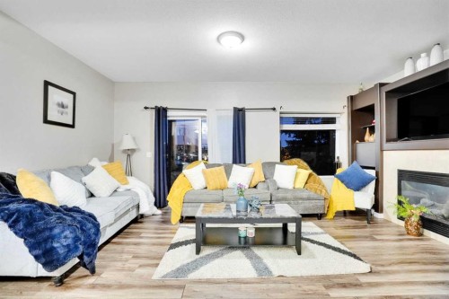 1004-720 Willowbrook Road Nw, Airdrie, AB - Indoor Photo Showing Living Room With Fireplace