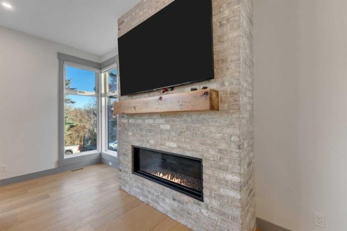 30 Roselawn Crescent Nw, Calgary, AB - Indoor Photo Showing Living Room With Fireplace