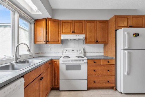 57 & 59 Dalton Bay Nw, Calgary, AB - Indoor Photo Showing Kitchen With Double Sink