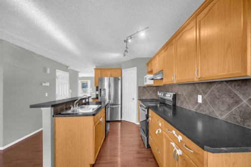 249 Covemeadow Road Ne, Calgary, AB - Indoor Photo Showing Kitchen With Double Sink