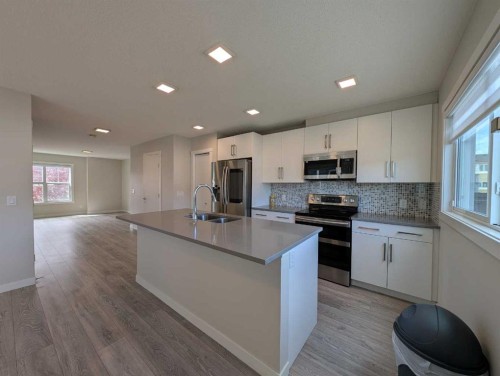 290 Fireside Drive, Cochrane, AB - Indoor Photo Showing Kitchen With Double Sink