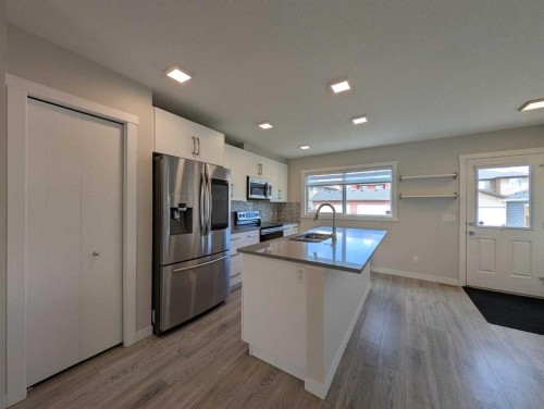 290 Fireside Drive, Cochrane, AB - Indoor Photo Showing Kitchen With Double Sink