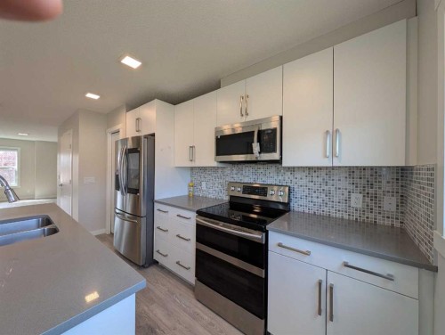 290 Fireside Drive, Cochrane, AB - Indoor Photo Showing Kitchen With Double Sink