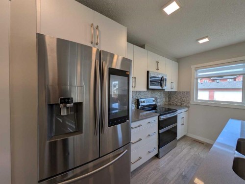 290 Fireside Drive, Cochrane, AB - Indoor Photo Showing Kitchen With Upgraded Kitchen
