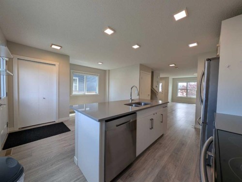 290 Fireside Drive, Cochrane, AB - Indoor Photo Showing Kitchen With Double Sink