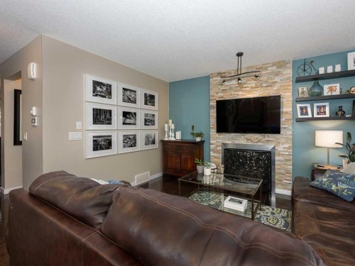 14 Walden Road Se, Calgary, AB - Indoor Photo Showing Living Room With Fireplace