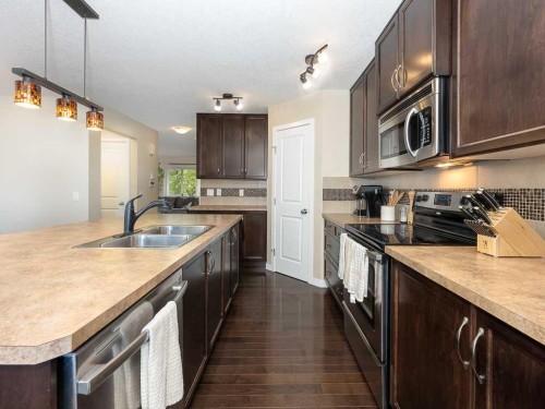 14 Walden Road Se, Calgary, AB - Indoor Photo Showing Kitchen With Double Sink