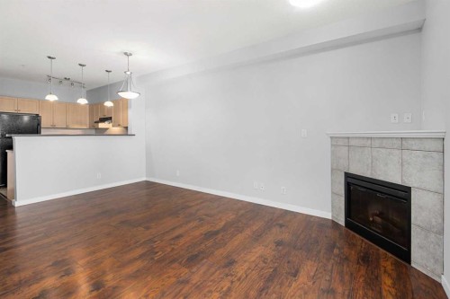 1203-333 Taravista Drive Ne, Calgary, AB - Indoor Photo Showing Living Room With Fireplace