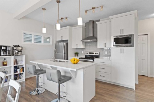 169 Buckskin Way, Cochrane, AB - Indoor Photo Showing Kitchen With Double Sink With Upgraded Kitchen