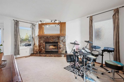 188 Christie Park Hill Sw, Calgary, AB - Indoor Photo Showing Living Room With Fireplace