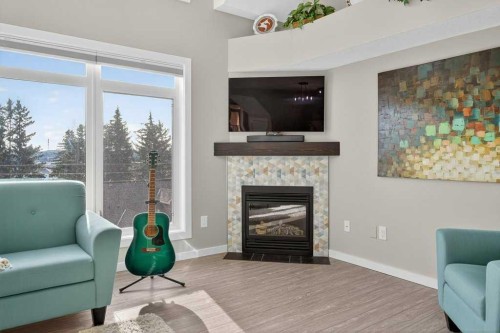 305-141 Mountain Street, Cochrane, AB - Indoor Photo Showing Living Room With Fireplace