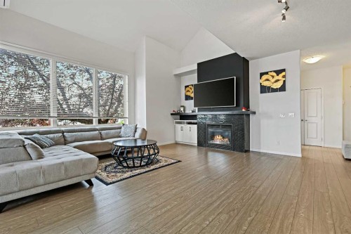 1-5616 14 Avenue Sw, Calgary, AB - Indoor Photo Showing Living Room With Fireplace