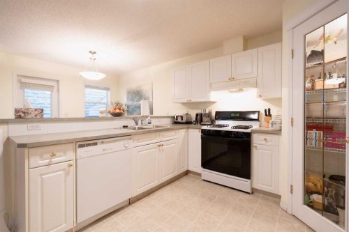 24 Hidden Creek Rise Nw, Calgary, AB - Indoor Photo Showing Kitchen With Double Sink
