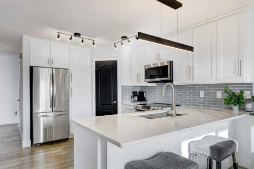 114 Chapalina Park Crescent Se, Calgary, AB - Indoor Photo Showing Kitchen With Stainless Steel Kitchen With Double Sink With Upgraded Kitchen