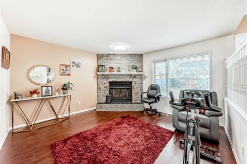 283 Macewan Drive Nw, Calgary, AB - Indoor Photo Showing Living Room With Fireplace