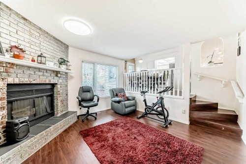 283 Macewan Drive Nw, Calgary, AB - Indoor Photo Showing Living Room With Fireplace