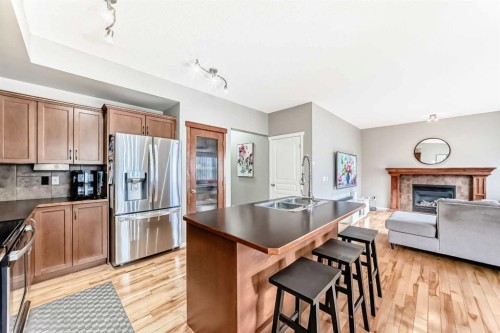 284 Sagewood Landing Sw, Airdrie, AB - Indoor Photo Showing Kitchen With Fireplace With Double Sink