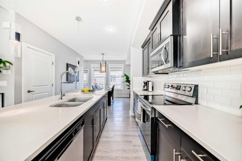 1349 Legacy Circle Se, Calgary, AB - Indoor Photo Showing Kitchen With Stainless Steel Kitchen With Double Sink With Upgraded Kitchen