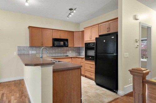 116 Tucker Circle, Okotoks, AB - Indoor Photo Showing Kitchen With Double Sink