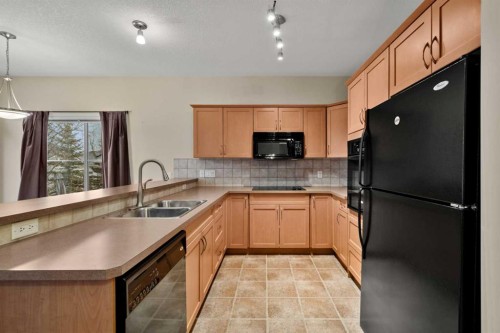 116 Tucker Circle, Okotoks, AB - Indoor Photo Showing Kitchen With Double Sink