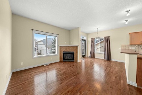 116 Tucker Circle, Okotoks, AB - Indoor Photo Showing Living Room With Fireplace