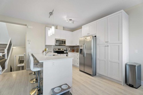 1191 Channelside Drive Sw, Airdrie, AB - Indoor Photo Showing Kitchen With Double Sink With Upgraded Kitchen