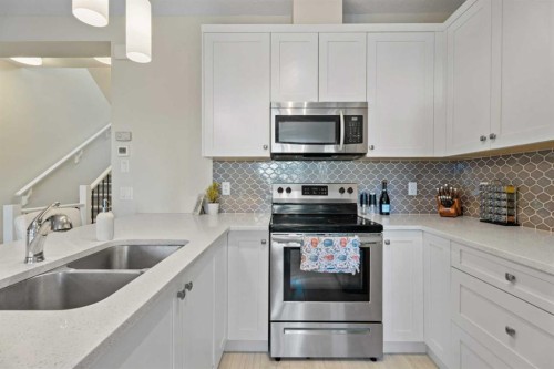 1191 Channelside Drive Sw, Airdrie, AB - Indoor Photo Showing Kitchen With Double Sink With Upgraded Kitchen