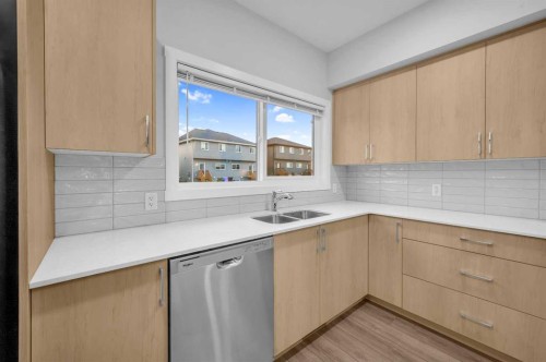 164 Legacy Reach Close Se, Calgary, AB - Indoor Photo Showing Kitchen With Double Sink