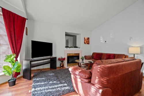6938 Laguna Way Ne, Calgary, AB - Indoor Photo Showing Living Room With Fireplace
