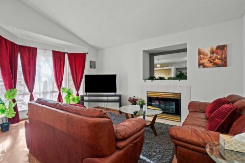 6938 Laguna Way Ne, Calgary, AB - Indoor Photo Showing Living Room With Fireplace