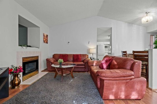 6938 Laguna Way Ne, Calgary, AB - Indoor Photo Showing Living Room With Fireplace