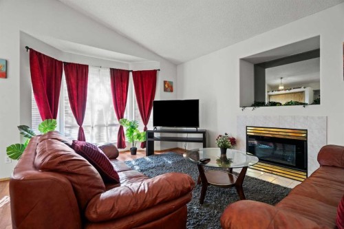 6938 Laguna Way Ne, Calgary, AB - Indoor Photo Showing Living Room With Fireplace