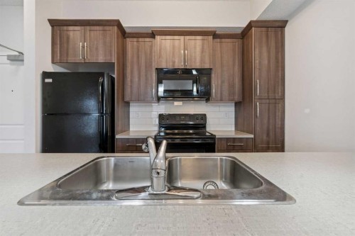 9314-101 Sunset Drive, Cochrane, AB - Indoor Photo Showing Kitchen With Double Sink