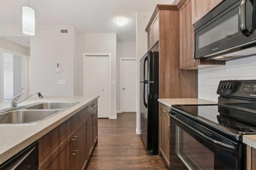9314-101 Sunset Drive, Cochrane, AB - Indoor Photo Showing Kitchen With Double Sink