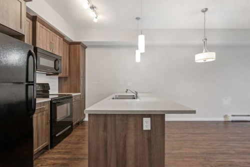 9314-101 Sunset Drive, Cochrane, AB - Indoor Photo Showing Kitchen With Double Sink With Upgraded Kitchen