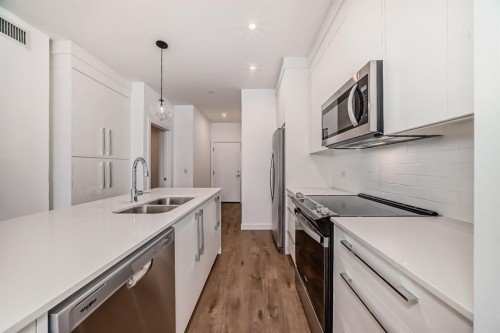 4416-6 Merganser Drive West, Chestermere, AB - Indoor Photo Showing Kitchen With Double Sink With Upgraded Kitchen