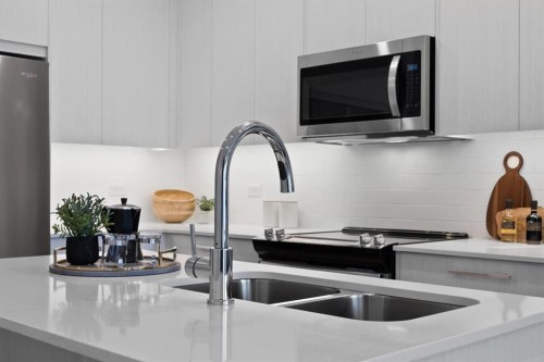 3314-6 Merganser Drive West, Chestermere, AB - Indoor Photo Showing Kitchen With Double Sink With Upgraded Kitchen